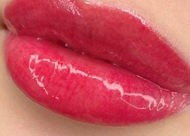 Close-up of glossy pink lips at Permanent Beauty by Cathy in Ottawa, Ontario, CA.