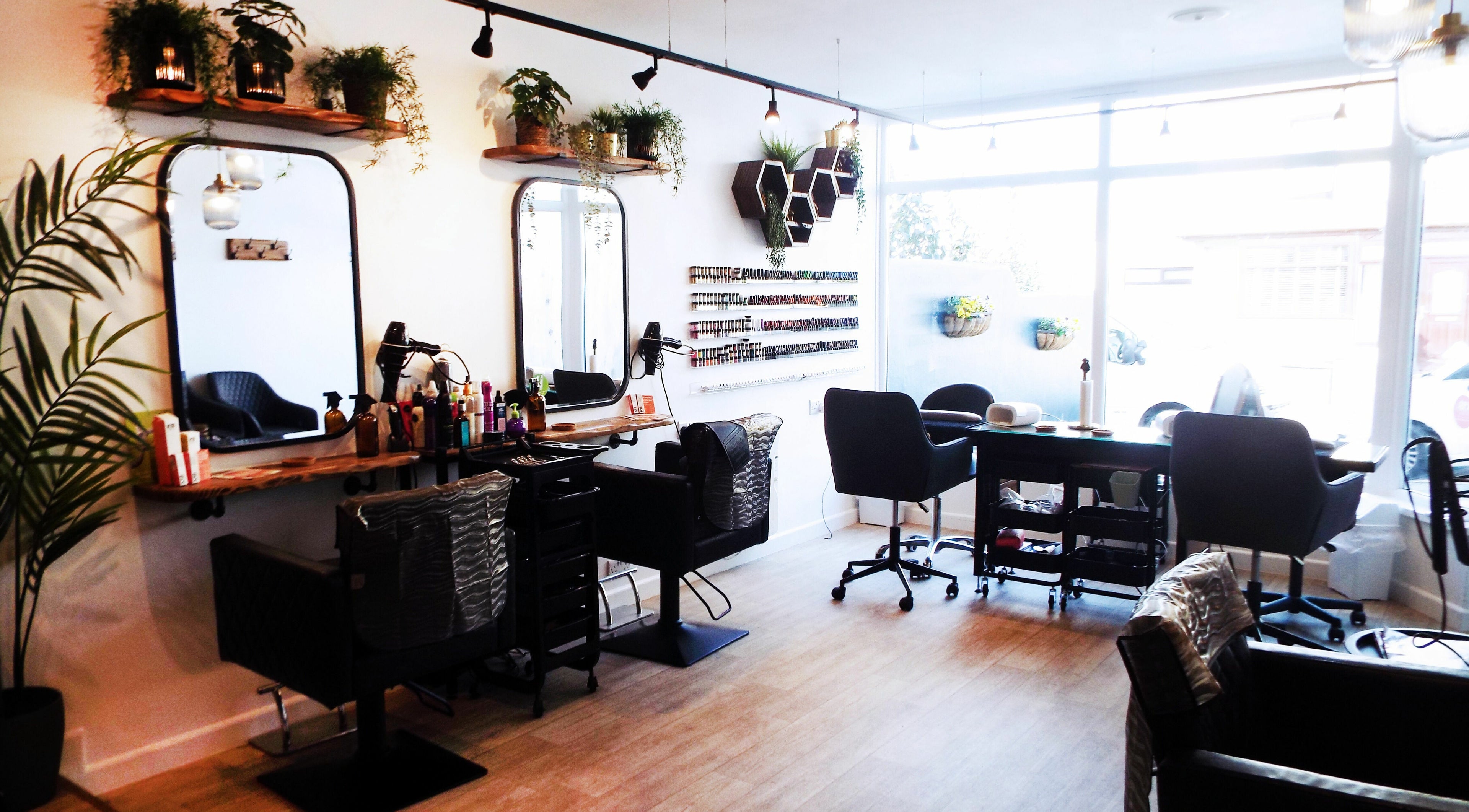 Stylish interior of Generations Hair Beauty Nails on Saint Columb Road, England, GB with modern salon furniture.
