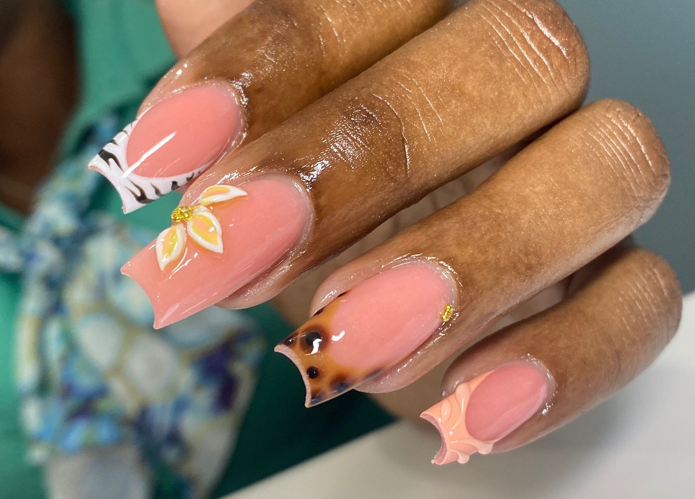 Intricate floral nail design at Atinas’ Nail Studio, Oistins, Christ Church, BB. Elegant style and artistry.