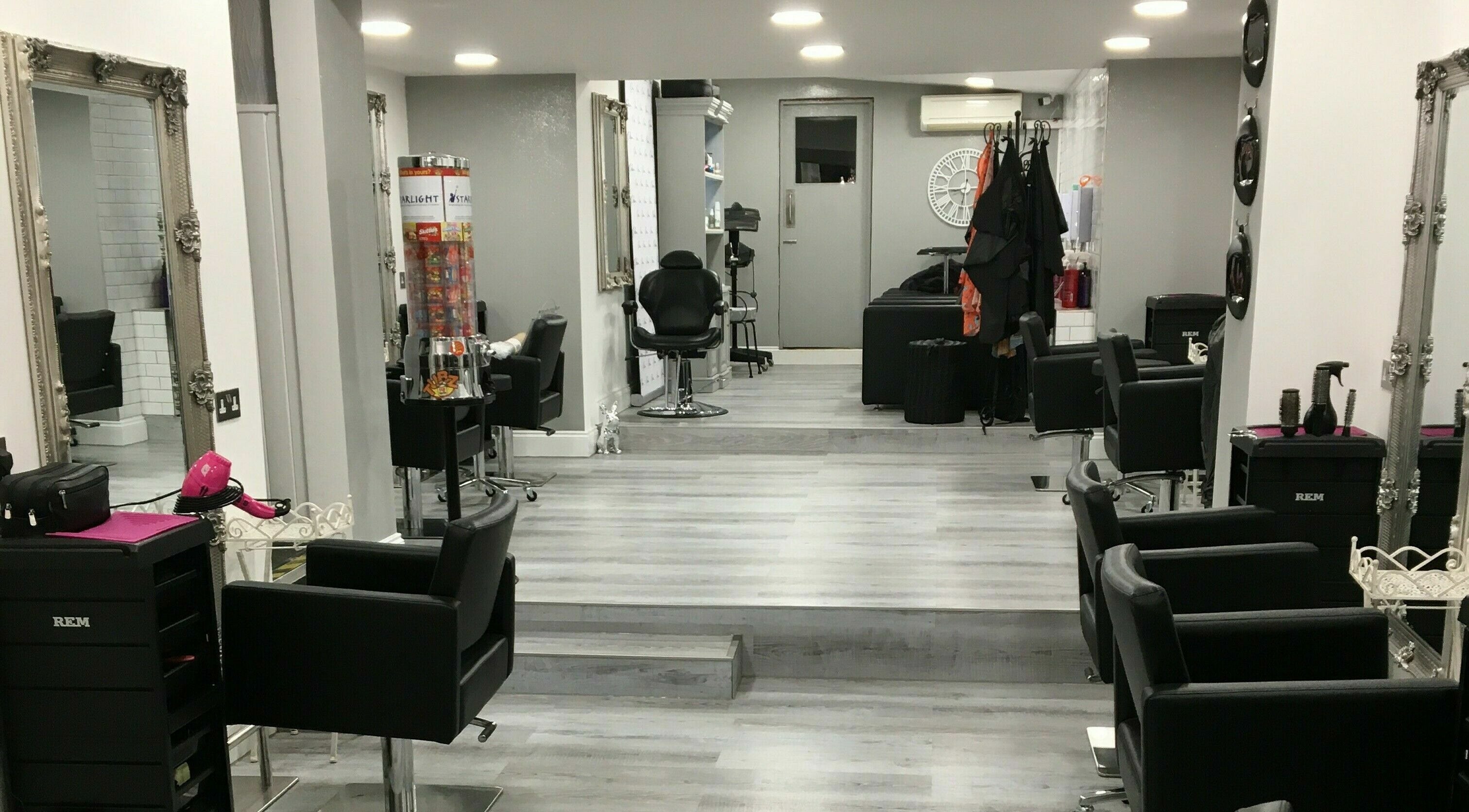 Modern interior of LPerfections Hair and Beauty in Chatham, England, GB featuring sleek salon chairs and mirrors.