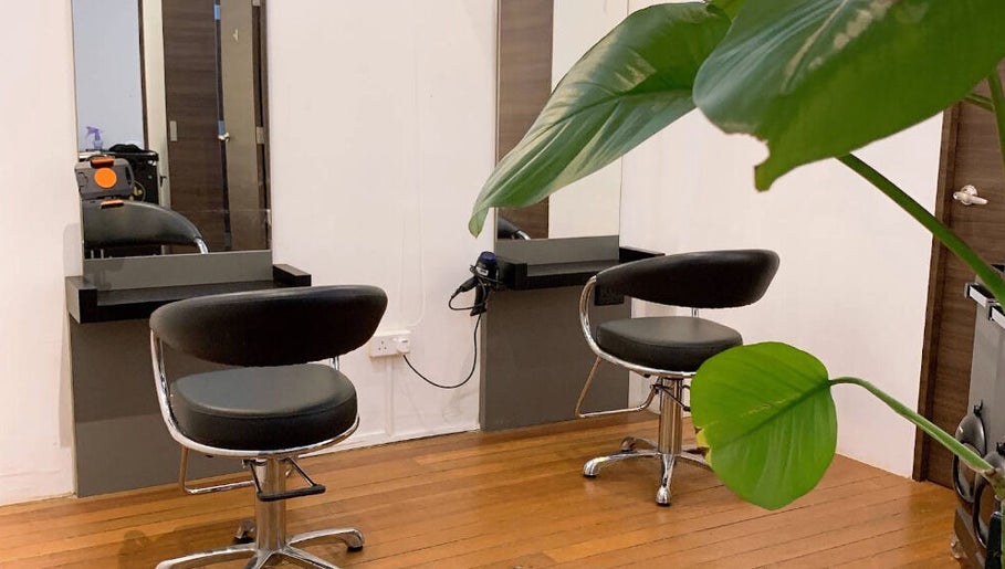 Modern salon chairs at I.C.O.N by Hair Visual, Singapore, Singapore, SG with sleek decor and lush plants.