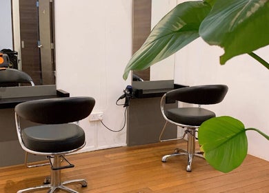 Modern salon chairs at I.C.O.N by Hair Visual, Singapore, Singapore, SG with sleek decor and lush plants.