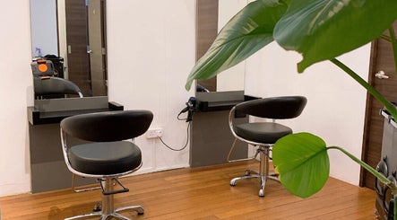 Modern salon chairs at I.C.O.N by Hair Visual, Singapore, Singapore, SG with sleek decor and lush plants.
