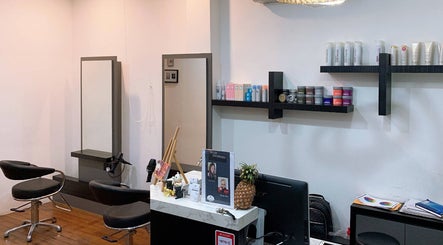 Contemporary interior of I.C.O.N by Hair Visual, Singapore, SG, showcasing stylish chairs and modern decor.