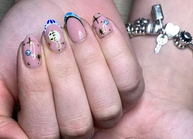 Artistic celestial nail design at The Nailwork Lounge, Mid Calder, Scotland, GB. Unique nail art showcase.