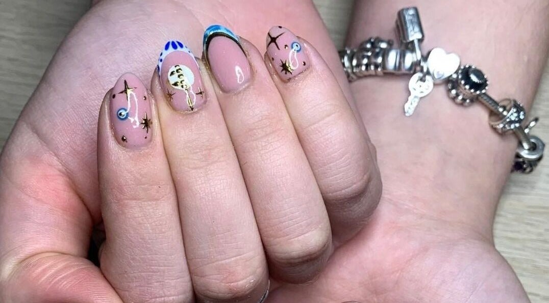 Artistic celestial nail design at The Nailwork Lounge, Mid Calder, Scotland, GB. Unique nail art showcase.