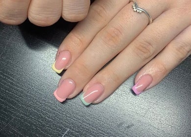 Colorful nail art at The Nailwork Lounge, Mid Calder, Scotland, GB showcasing pastel French tips.