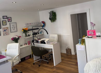 Stylish interior of Painted Nails and Beauty in Dunbar, Scotland, GB, featuring nail stations and decor.