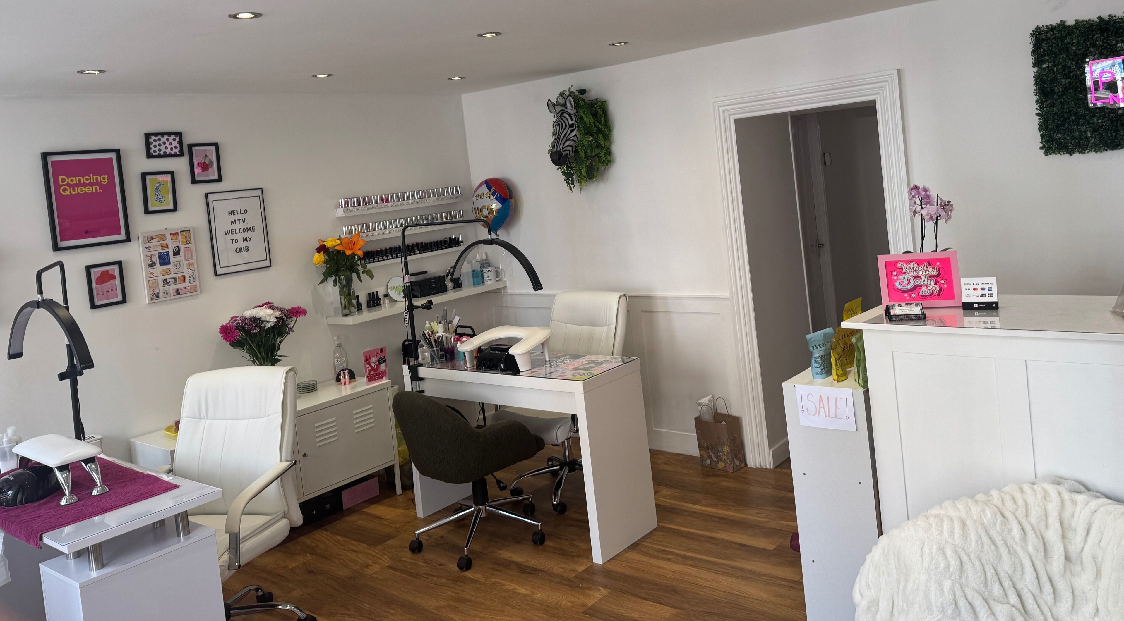 Stylish interior of Painted Nails and Beauty in Dunbar, Scotland, GB, featuring nail stations and decor.