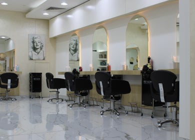 Modern salon interior at Kals Ladies Salon, Dubai, Dubai, AE, featuring stylish chairs and mirrors.