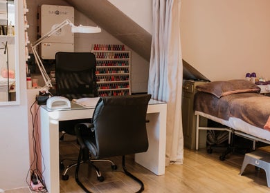 Tranquil treatment area at Inge Myburgh Studio, Cape Town, Western Cape, ZA, featuring a manicure station and massage bed.