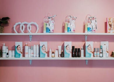 Inge Myburgh Studio's skincare display on pink wall in Cape Town, Western Cape, ZA.