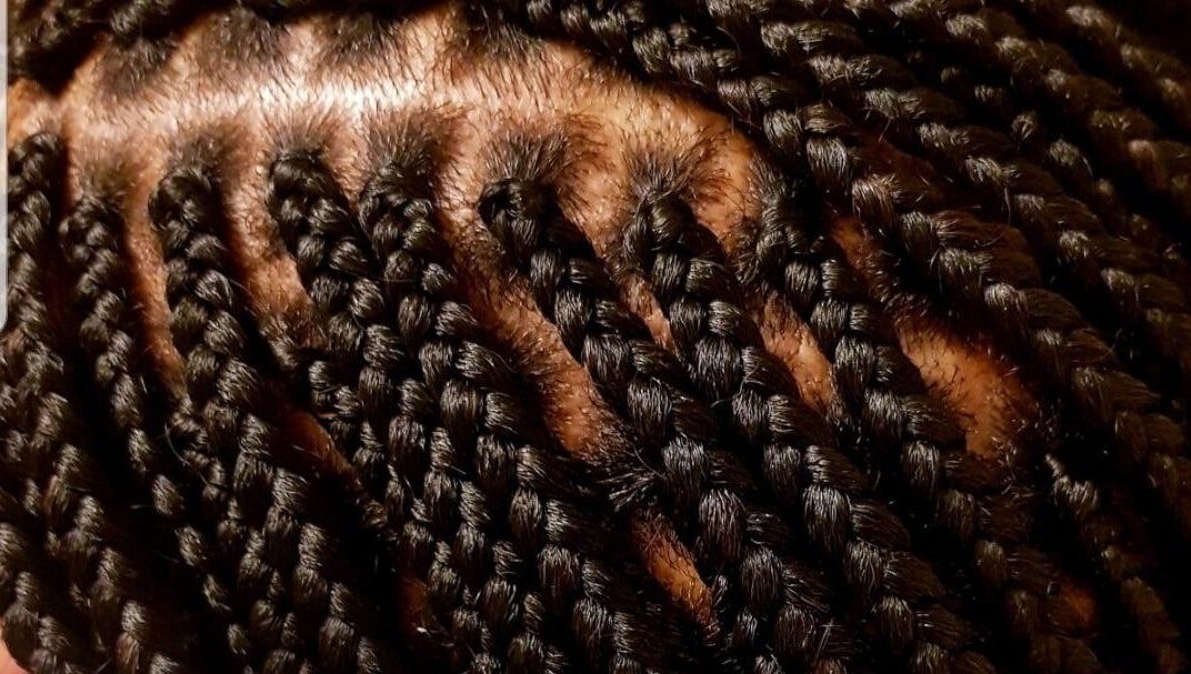 Close-up of intricate braids at AmiCable Braids, Grantham, England, GB, showcasing sleek styling.