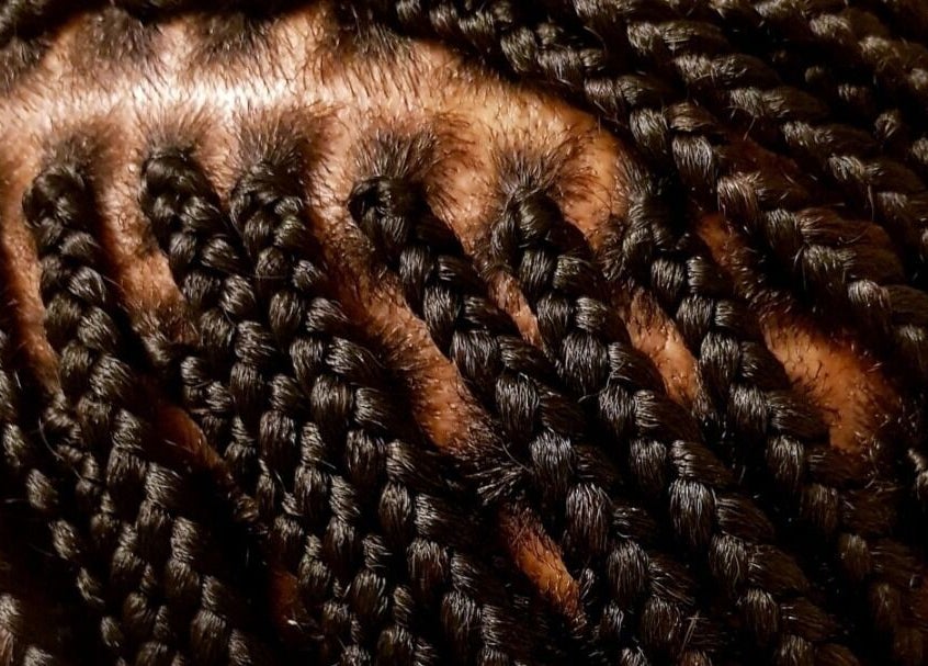 Close-up of intricate braids at AmiCable Braids, Grantham, England, GB, showcasing sleek styling.