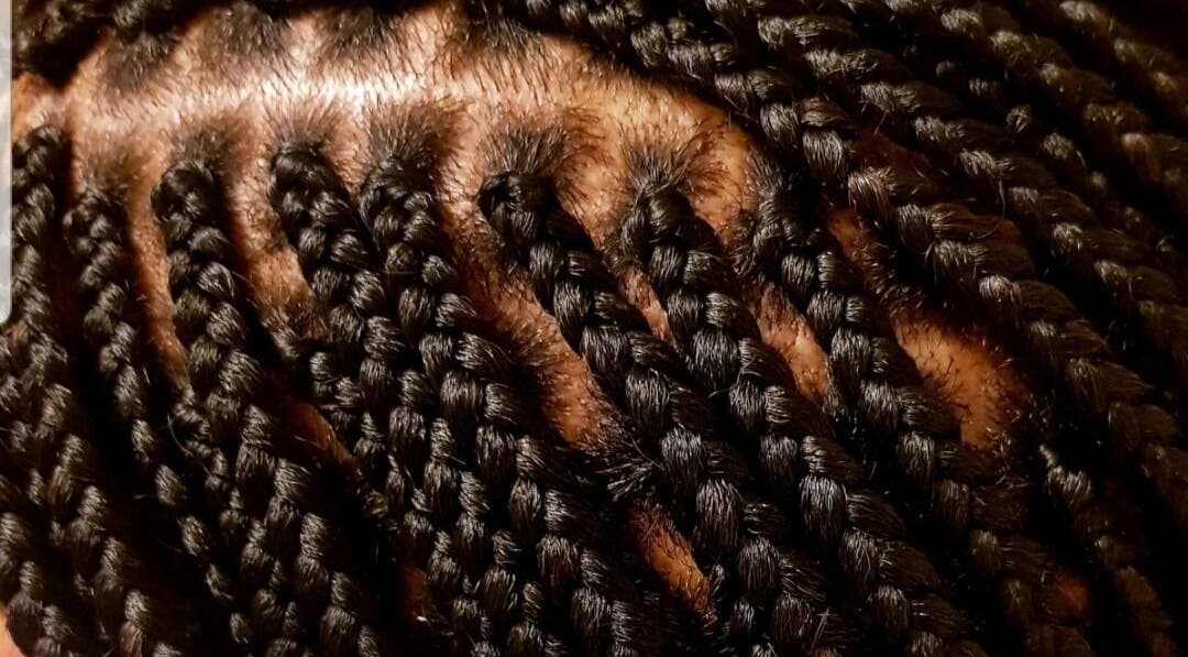 Close-up of intricate braids at AmiCable Braids, Grantham, England, GB, showcasing sleek styling.