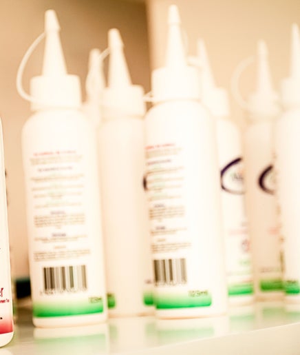 Kurlz & Kutz in Johannesburg, Gauteng, ZA displays a variety of conditioner products on a shelf.