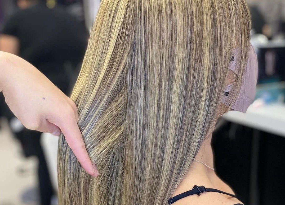 Blonde highlights at Hyper Cut Salon, Cape Town, Western Cape, ZA. Smooth and styled hair.