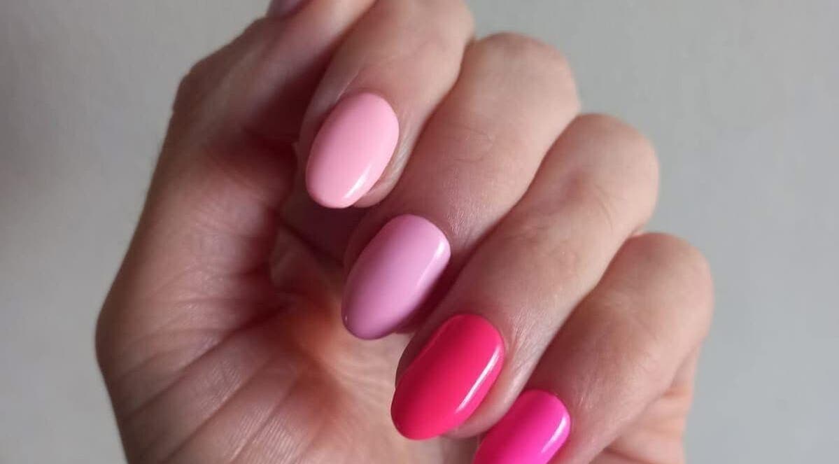 Vibrant pink manicure at The Spoil Spot, Benoni, Gauteng, ZA showcasing a polished nail finish.