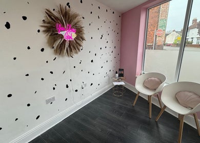 Stylish waiting area at Glow Beauty and Aesthetics, Newhall, England, GB with modern decor and seating.