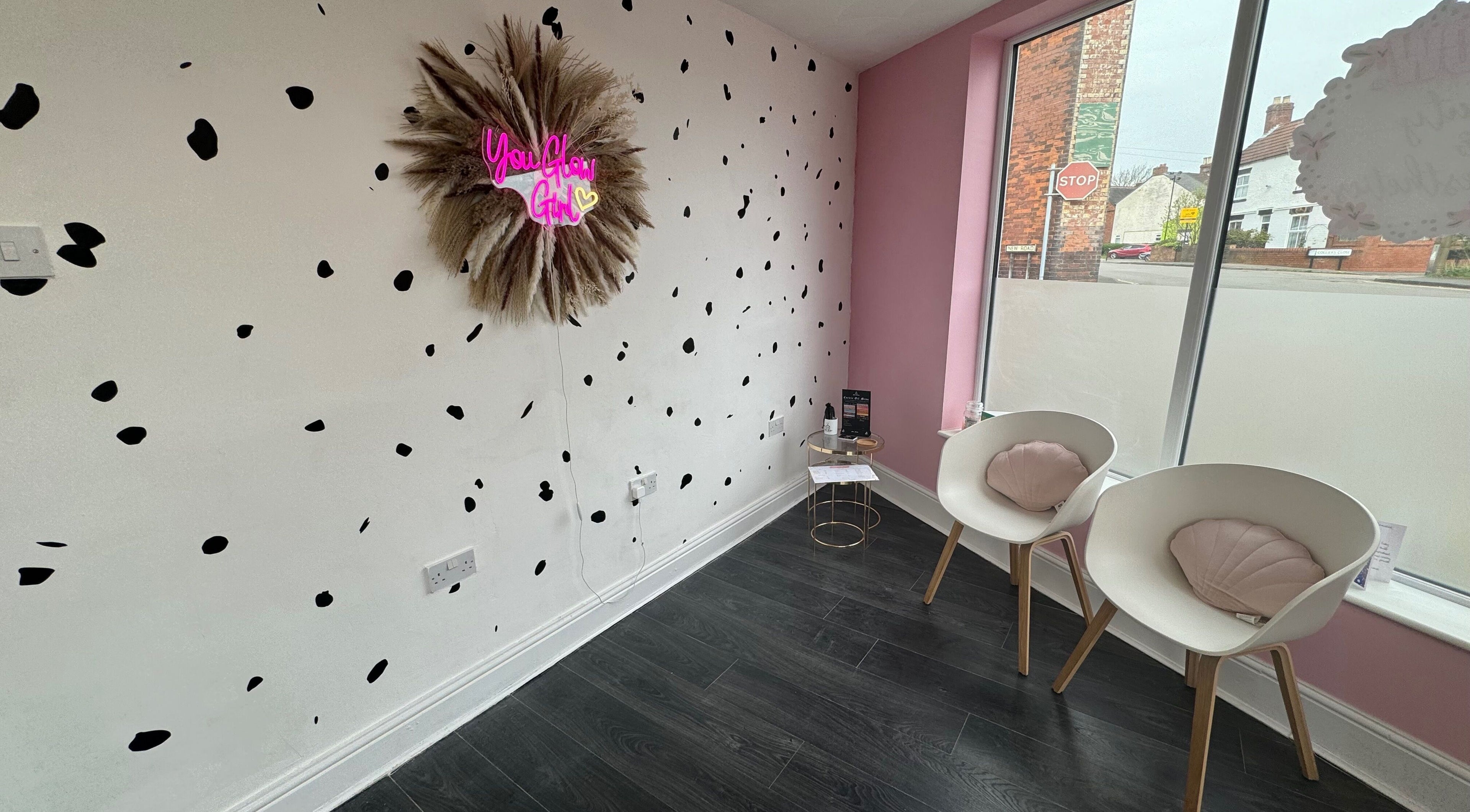 Stylish waiting area at Glow Beauty and Aesthetics, Newhall, England, GB with modern decor and seating.