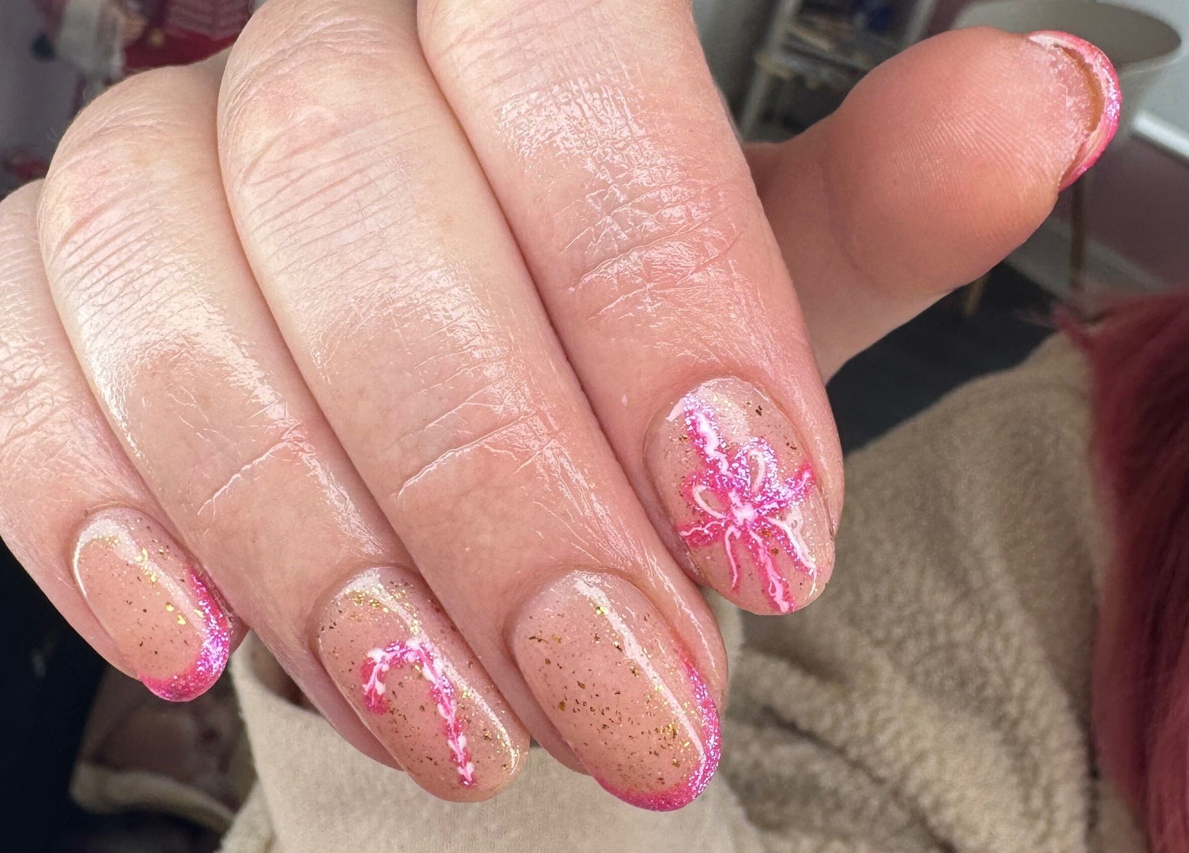 Close-up of pink glitter nail art at Glow Beauty and Aesthetics, Newhall, England, GB, showcasing intricate designs.