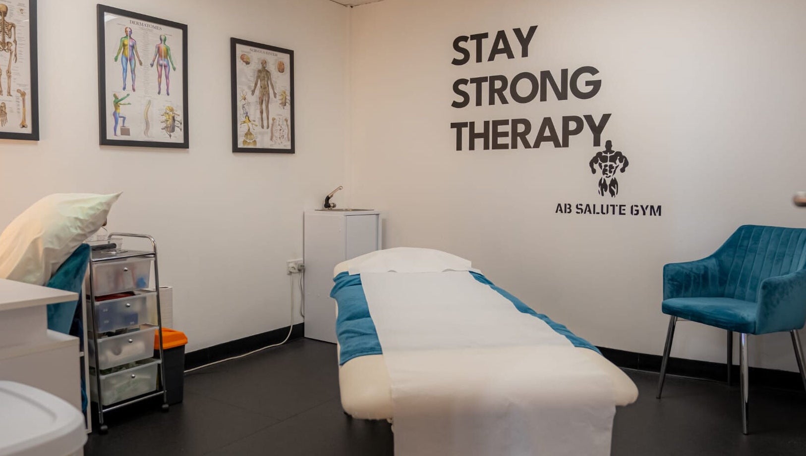 Stay Strong Therapy room in Braintree, England, GB with massage bed, anatomy charts, and inviting atmosphere.