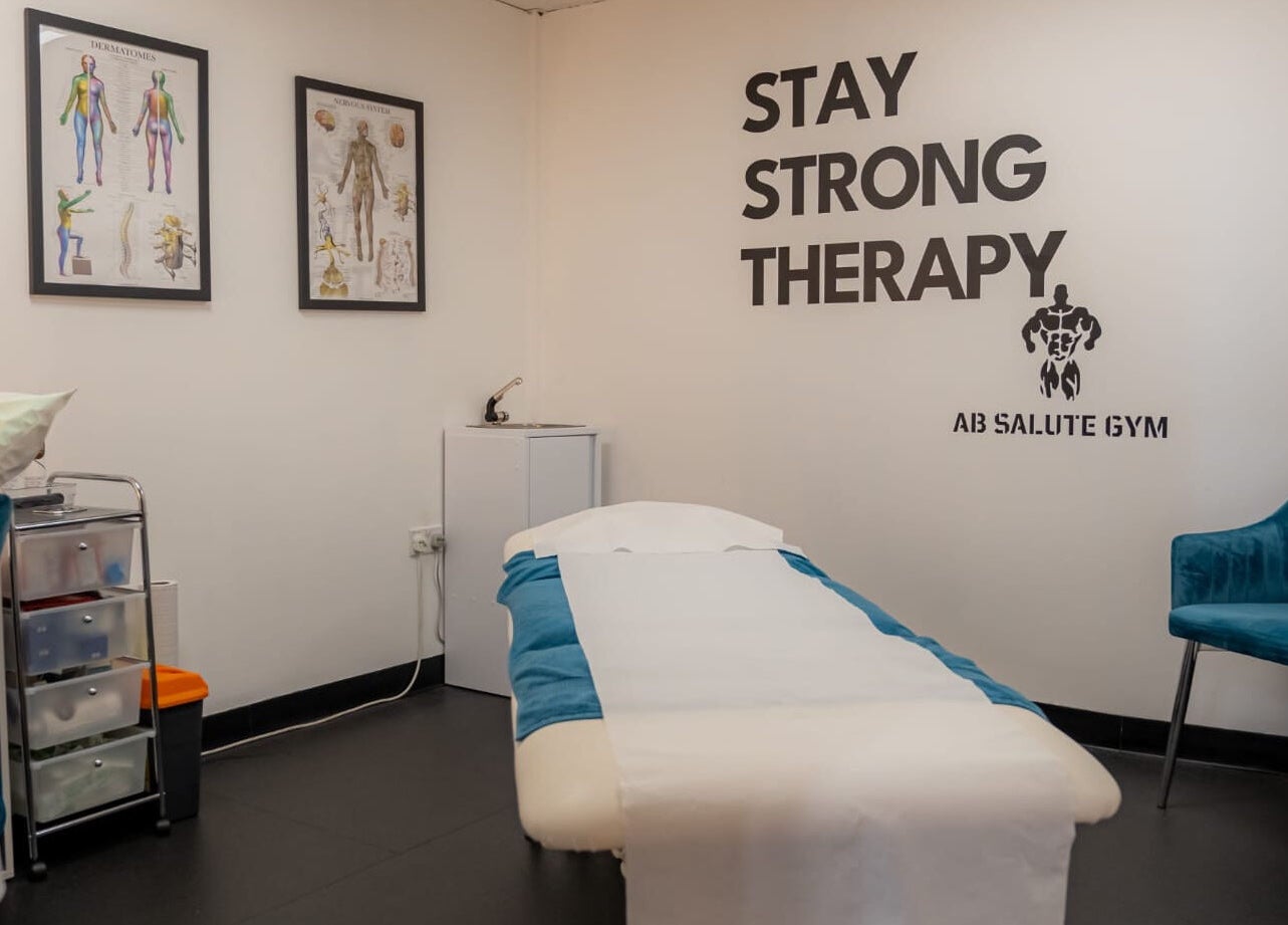 Stay Strong Therapy room in Braintree, England, GB with massage bed, anatomy charts, and inviting atmosphere.