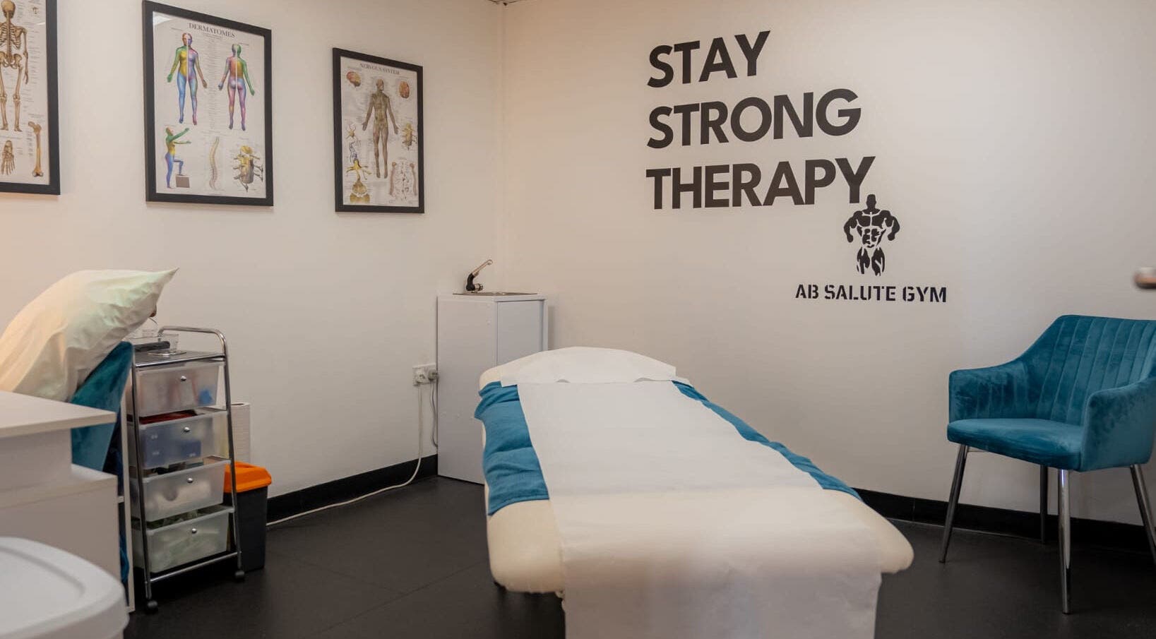 Stay Strong Therapy room in Braintree, England, GB with massage bed, anatomy charts, and inviting atmosphere.