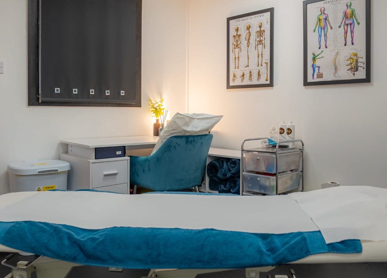 Stay Strong Therapy's tranquil therapy room in Braintree, England, GB, featuring a treatment bed and anatomical charts.
