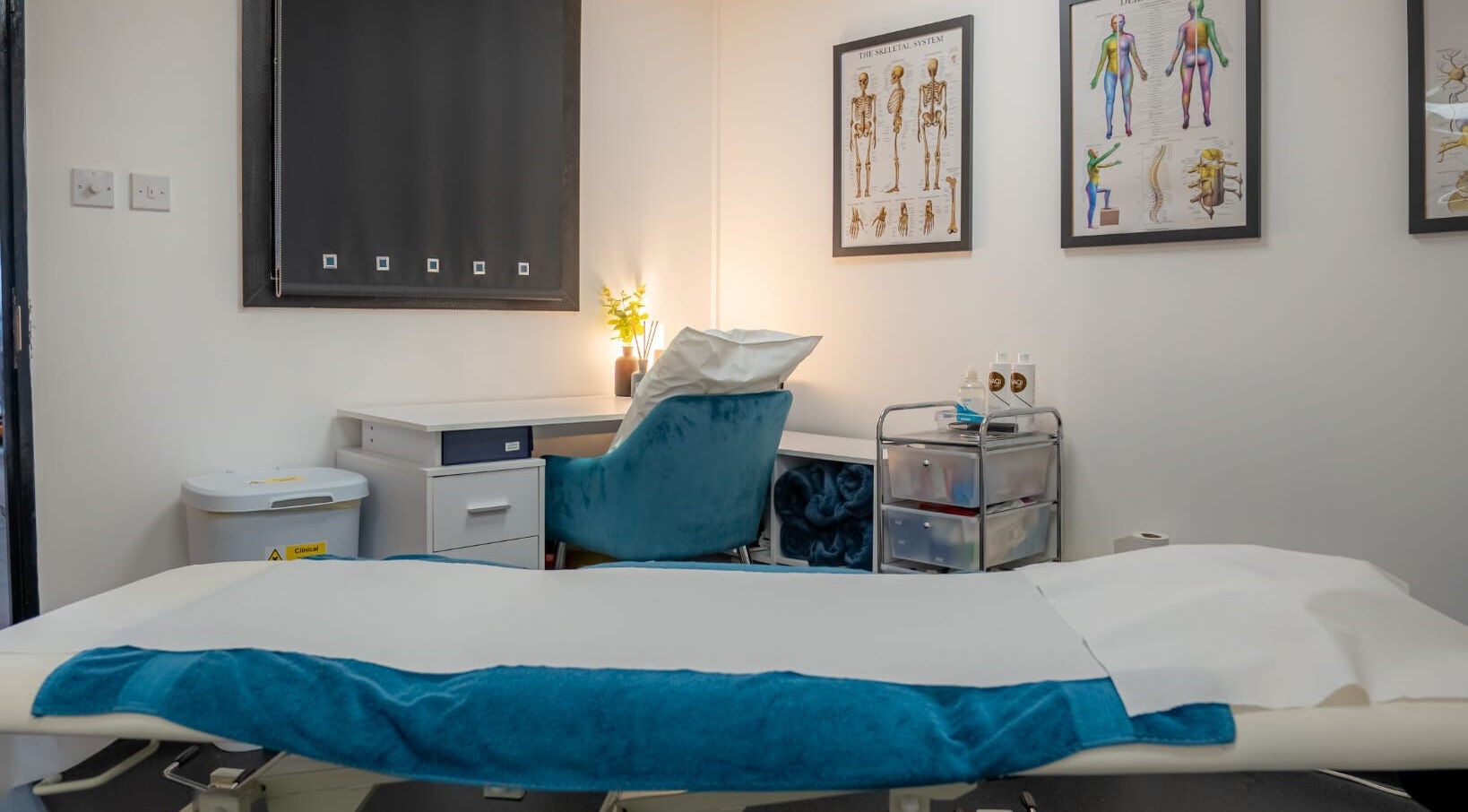 Stay Strong Therapy's tranquil therapy room in Braintree, England, GB, featuring a treatment bed and anatomical charts.