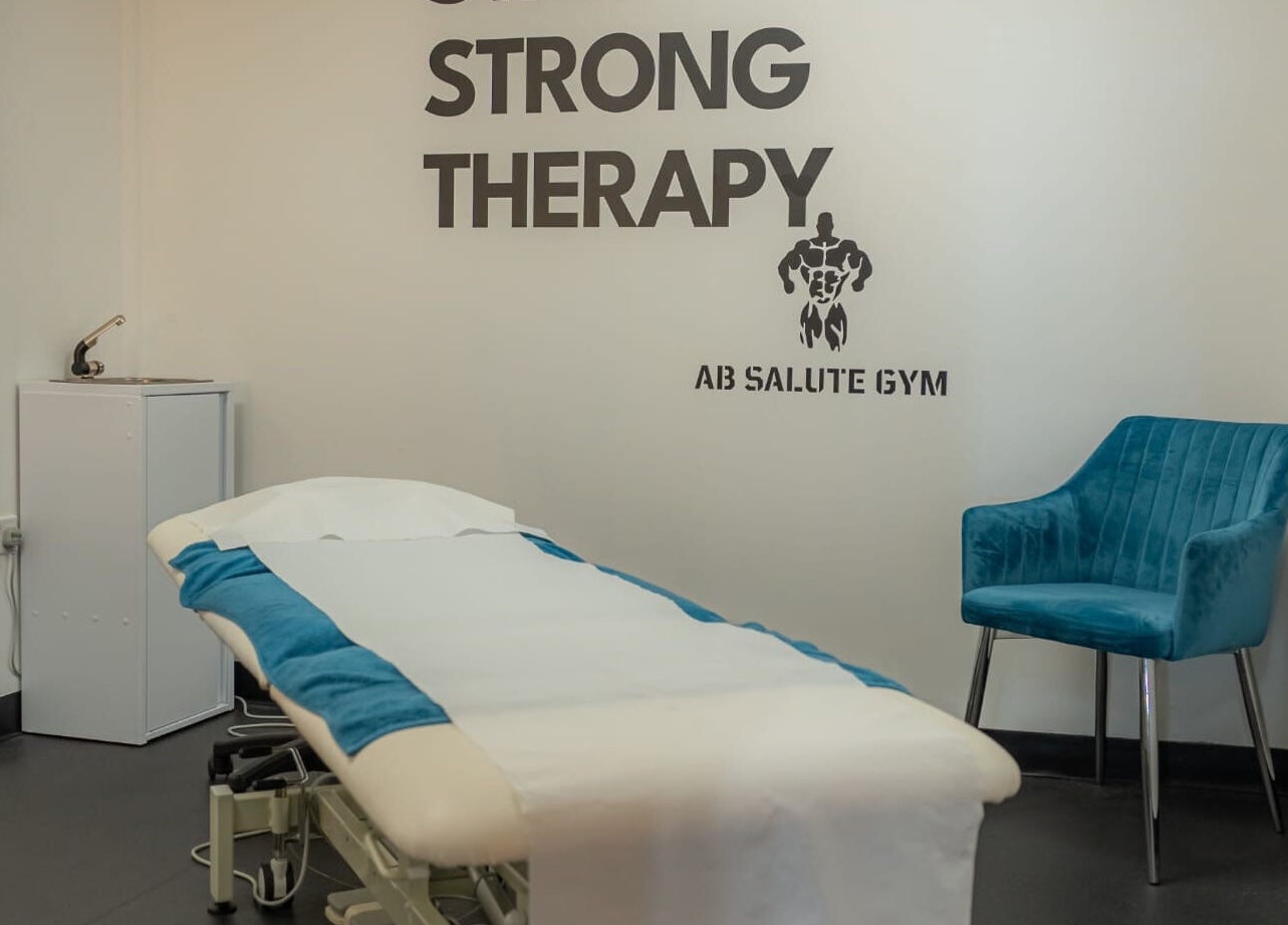 Stay Strong Therapy room in Braintree, England, GB with a treatment table and blue chair.