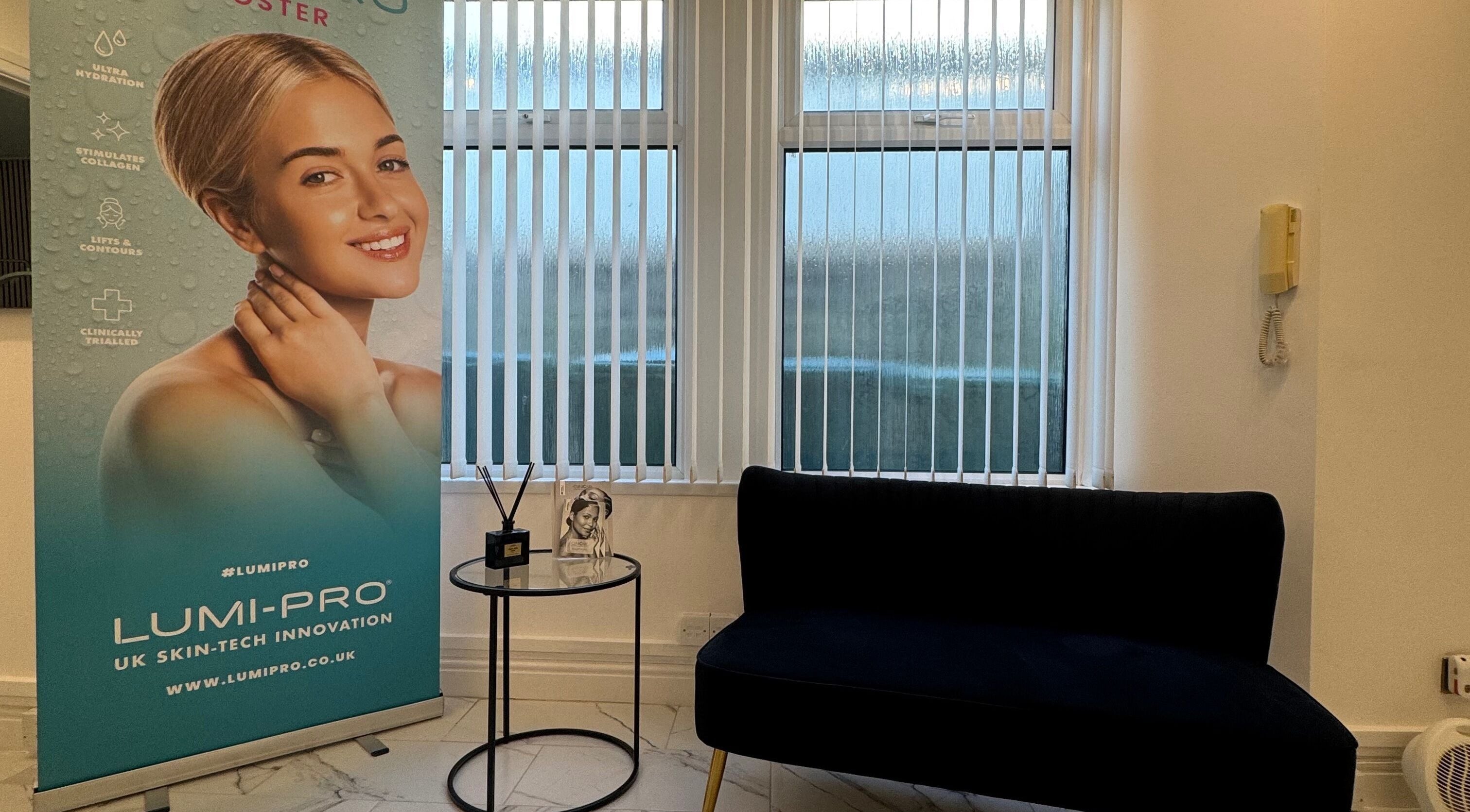 Comfortable seating area at JM Cosmetics & Skin Clinic, Penarth, Wales, GB showing promotional banner.