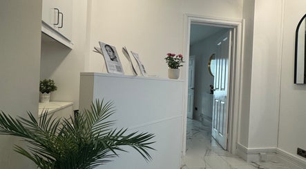 Elegant reception area at JM Cosmetics & Skin Clinic, Penarth, Wales, GB showcasing modern decor and plants.