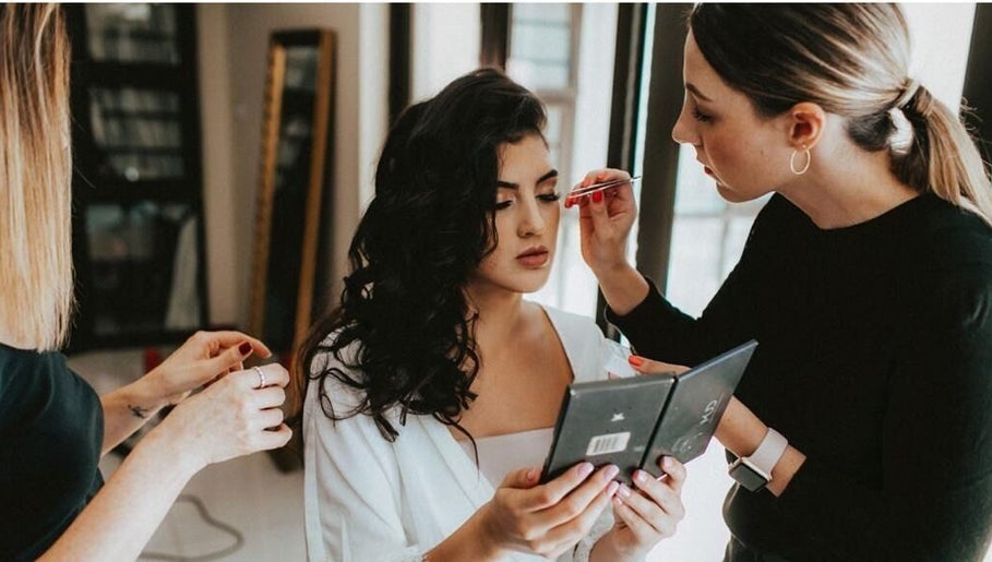 Makeup artist at Studio Luxe Collective, Bloemfontein, Free State, ZA, applying makeup to woman.