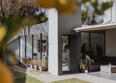 Exterior view of Studio Luxe Collective in Bloemfontein, showcasing modern glass features and inviting spaces.
