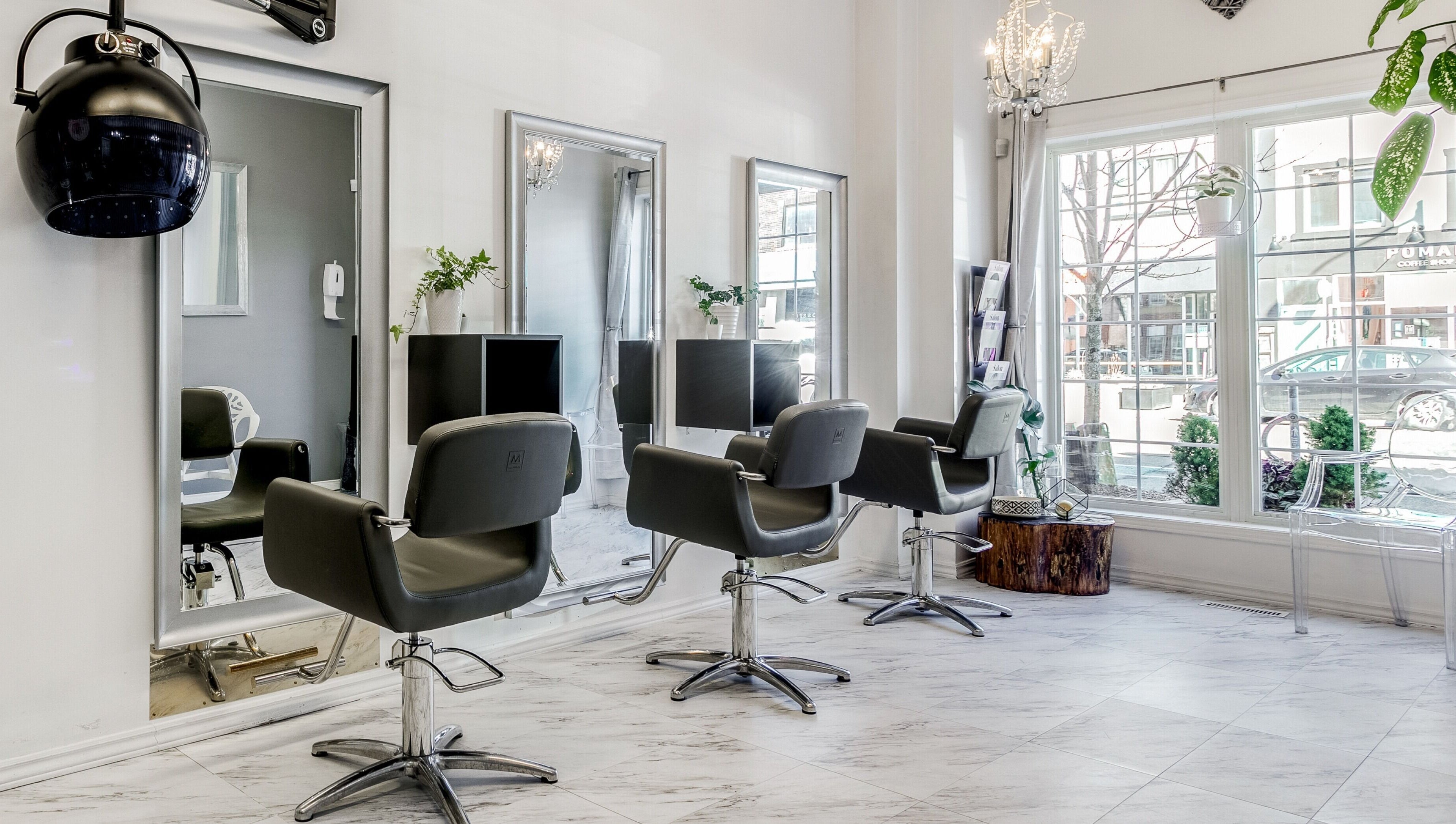 Interior of Carin's Hair Studio in Toronto, Ontario, CA featuring stylish chairs and modern decor.