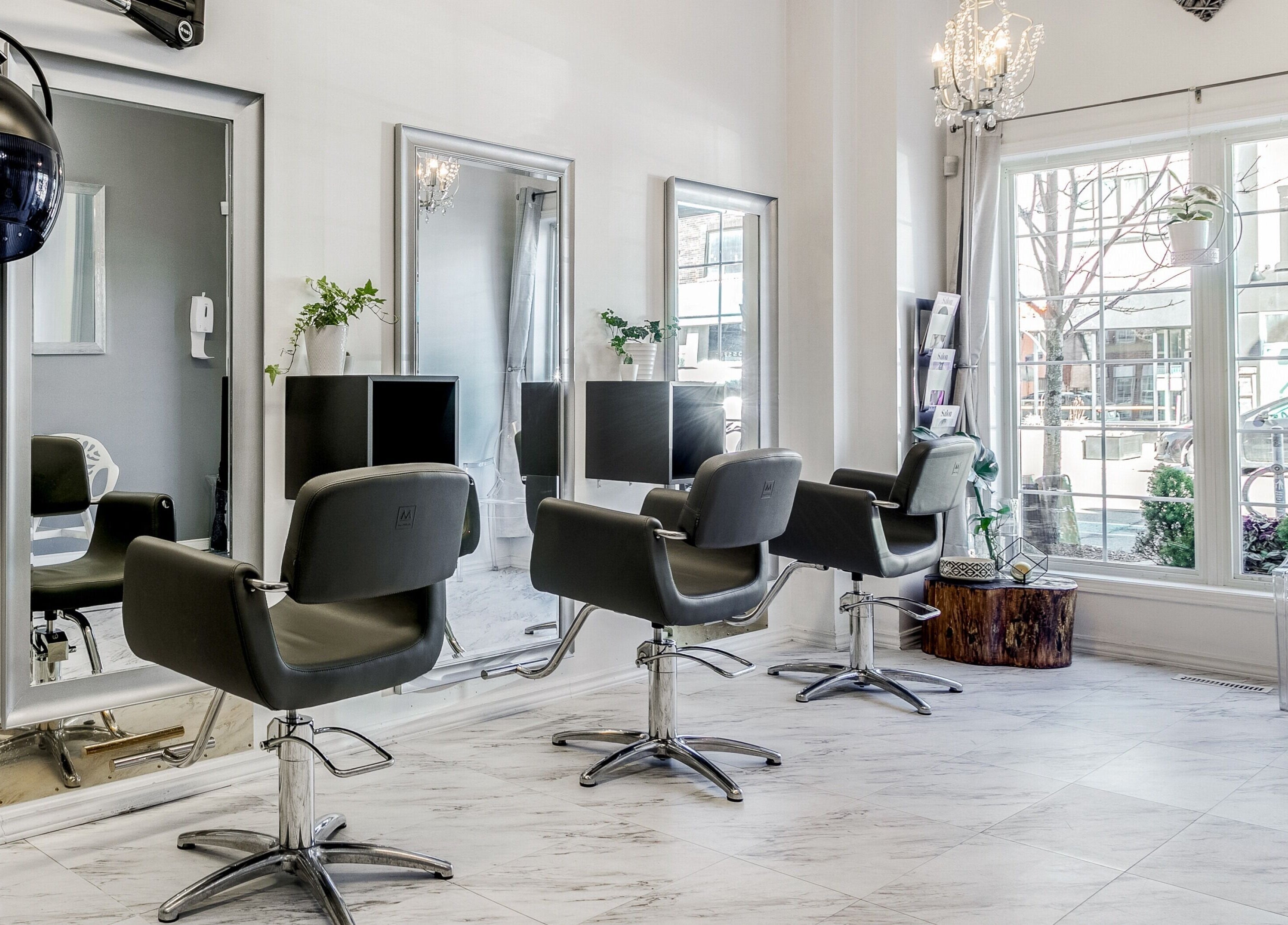 Interior of Carin's Hair Studio in Toronto, Ontario, CA featuring stylish chairs and modern decor.