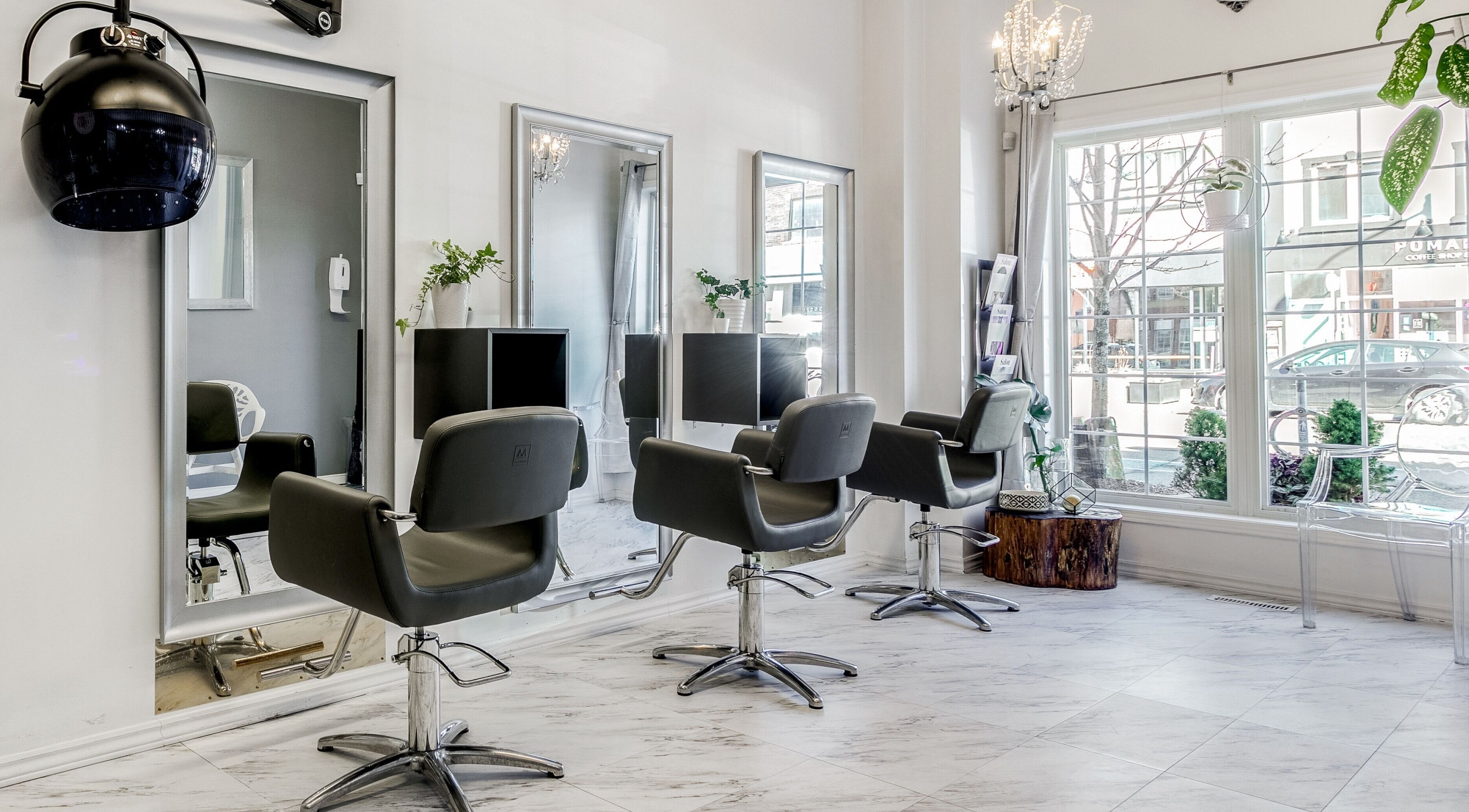 Interior of Carin's Hair Studio in Toronto, Ontario, CA featuring stylish chairs and modern decor.