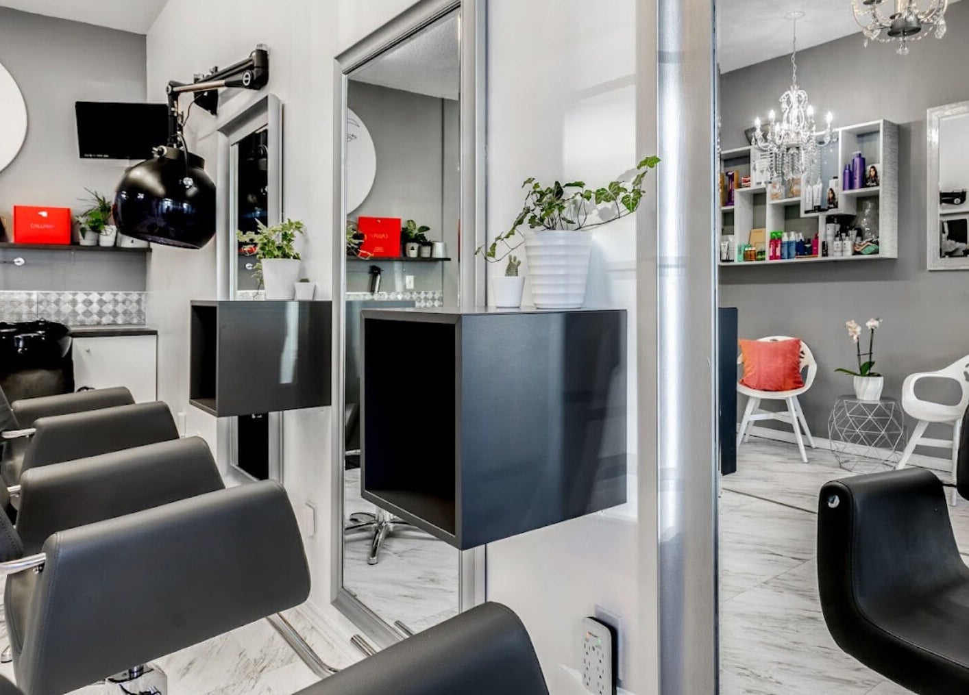 Modern interior of Carin's Hair Studio in Toronto, Ontario, CA with stylish chairs and elegant decor.