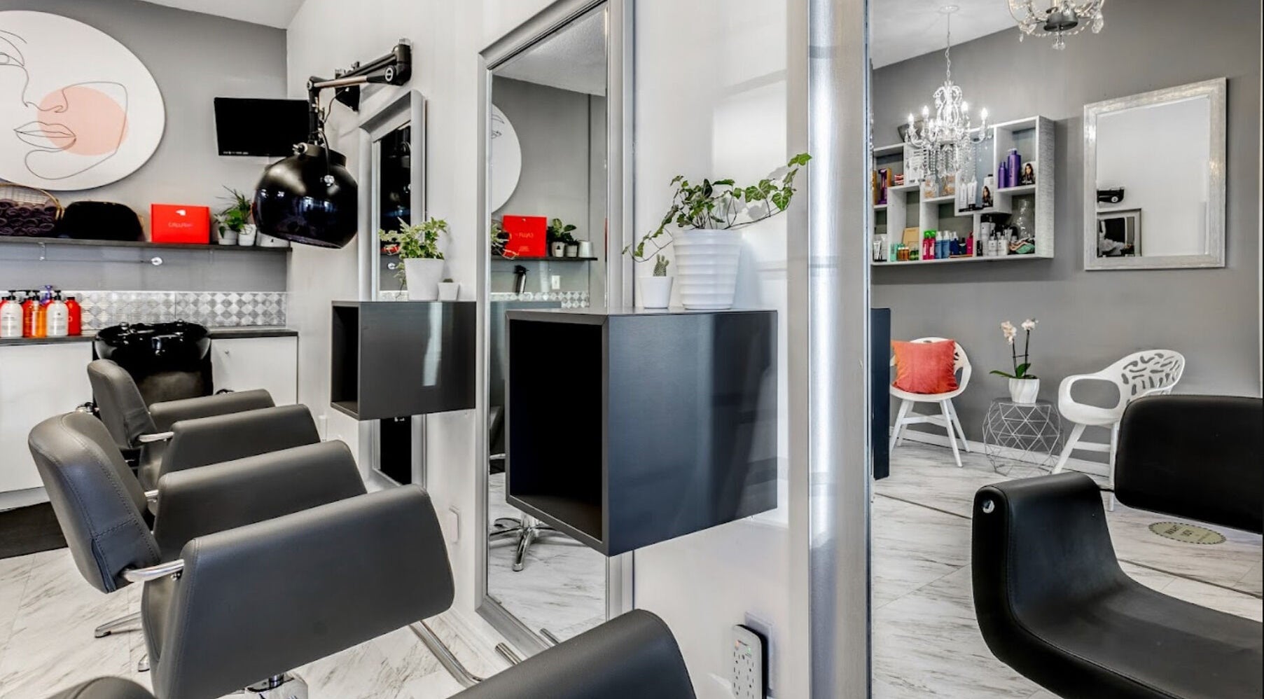 Modern interior of Carin's Hair Studio in Toronto, Ontario, CA with stylish chairs and elegant decor.