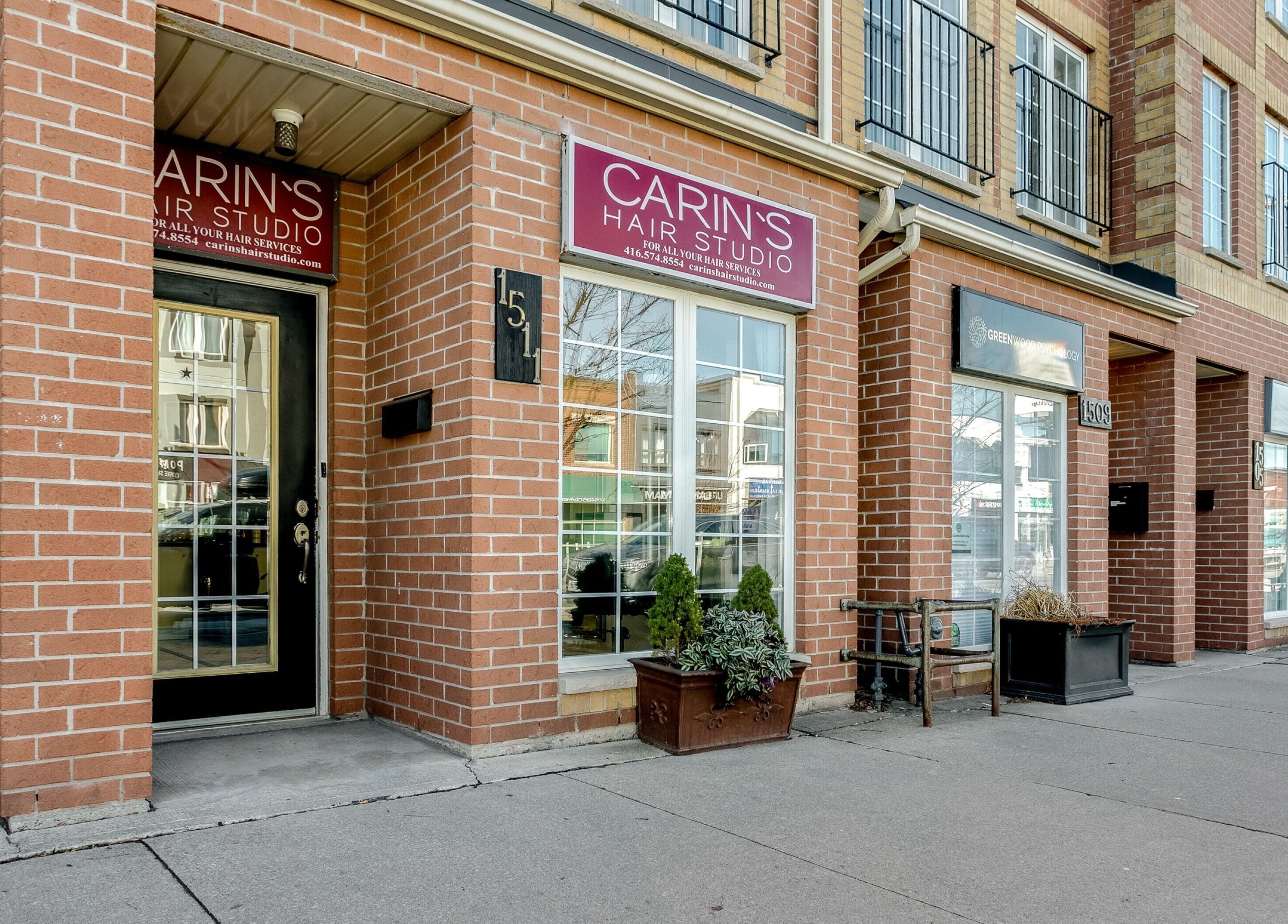 Carin's Hair Studio entrance with brick facade in Toronto, Ontario, CA, showcasing a chic urban vibe.