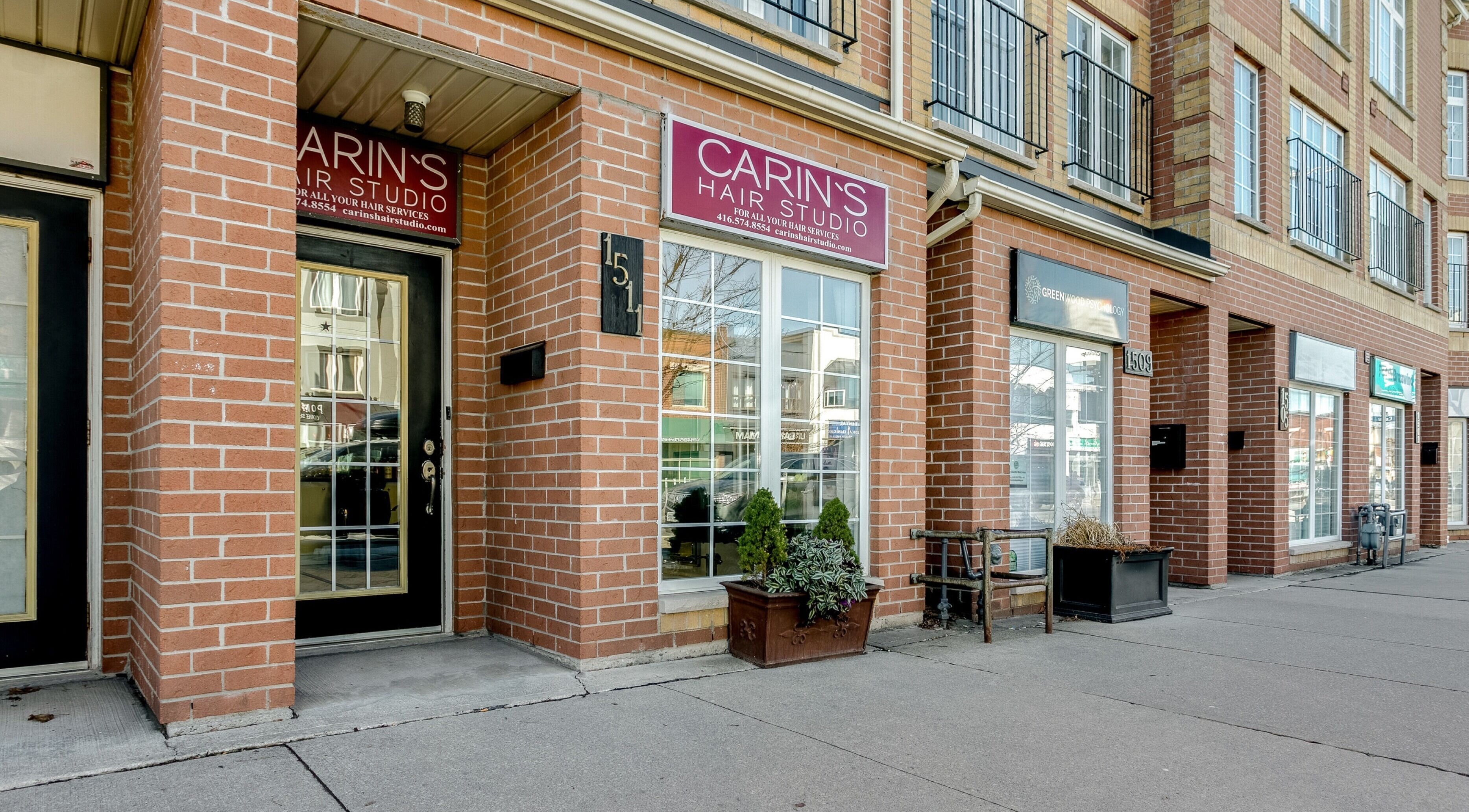 Carin's Hair Studio entrance with brick facade in Toronto, Ontario, CA, showcasing a chic urban vibe.