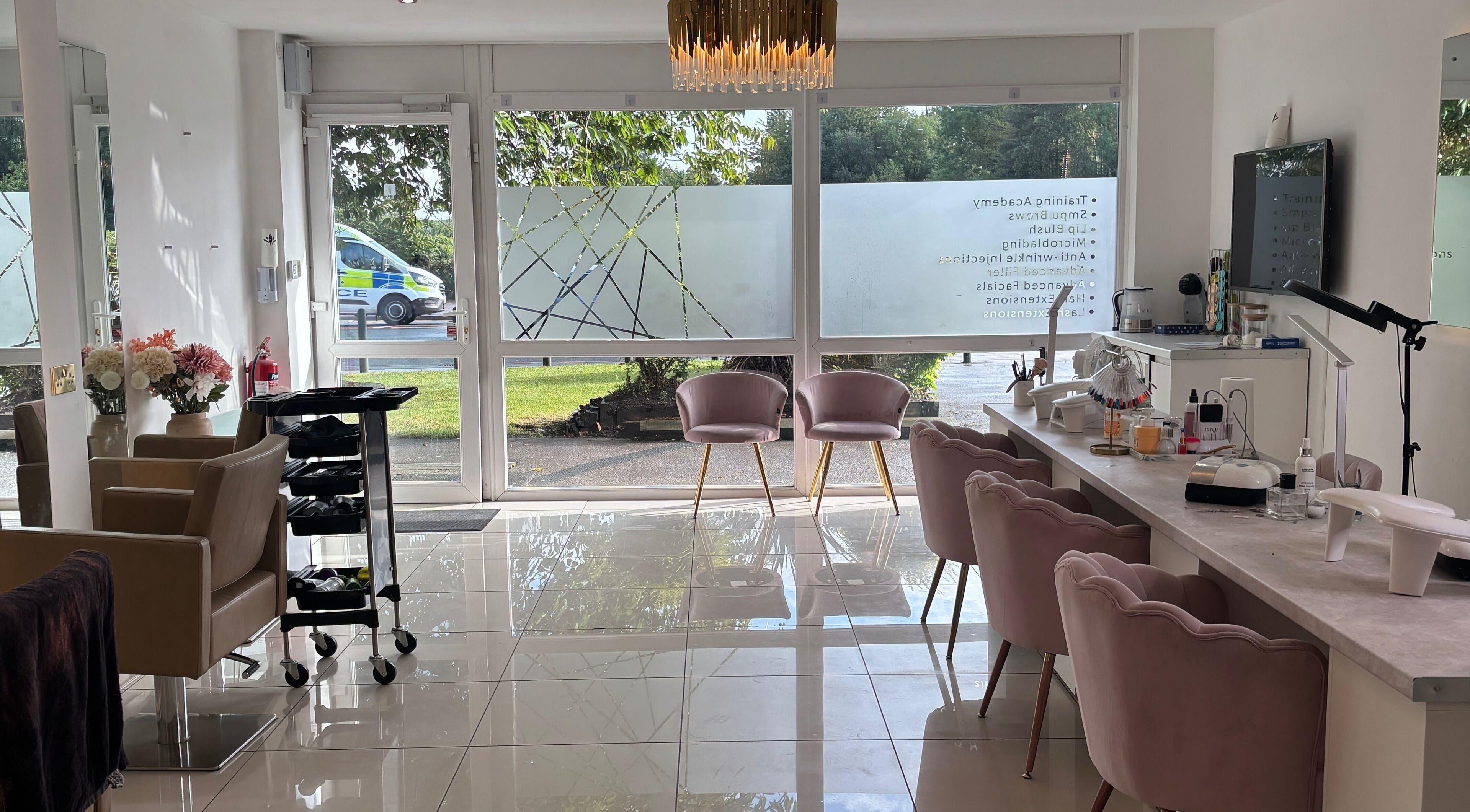 Interior of LUMA Laser and Beauty in Salford, England, featuring elegant seating and bright natural light.