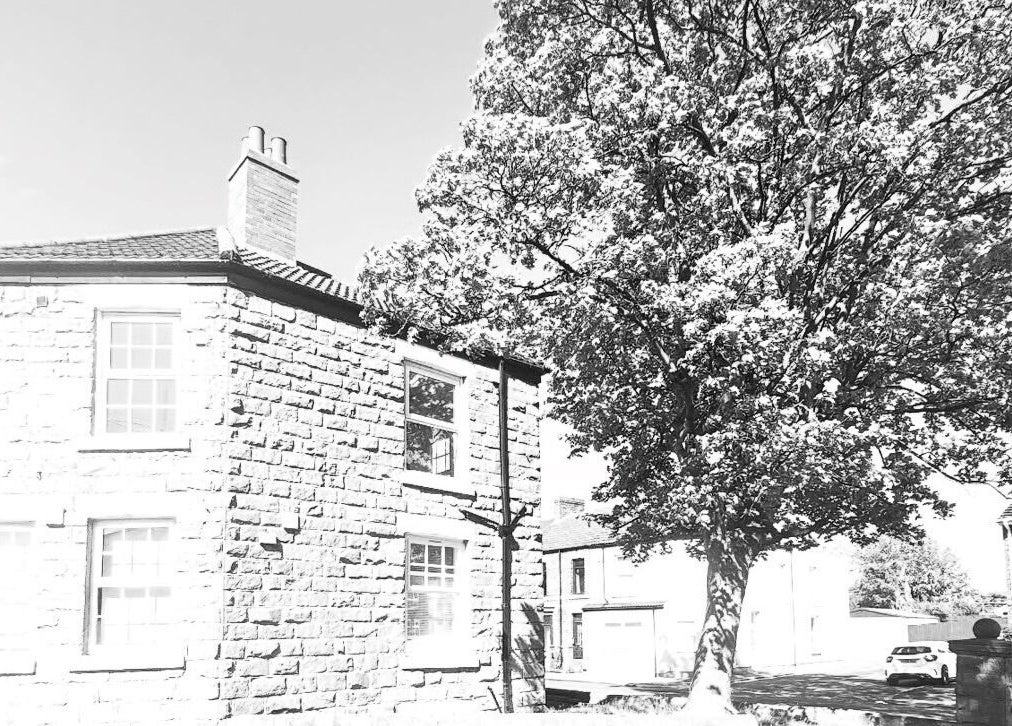 Exterior of NS Aesthetics & Beauty, Shildon, England, featuring a charming stone building and lush tree.