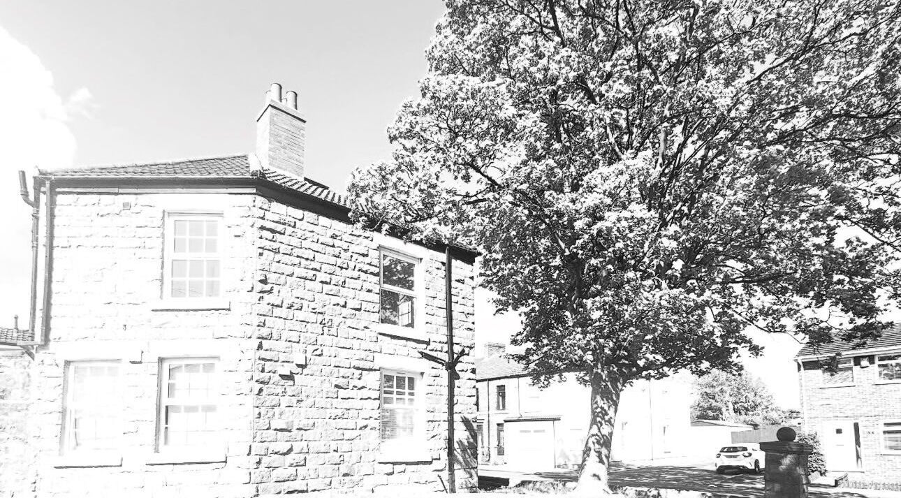 Exterior of NS Aesthetics & Beauty, Shildon, England, featuring a charming stone building and lush tree.