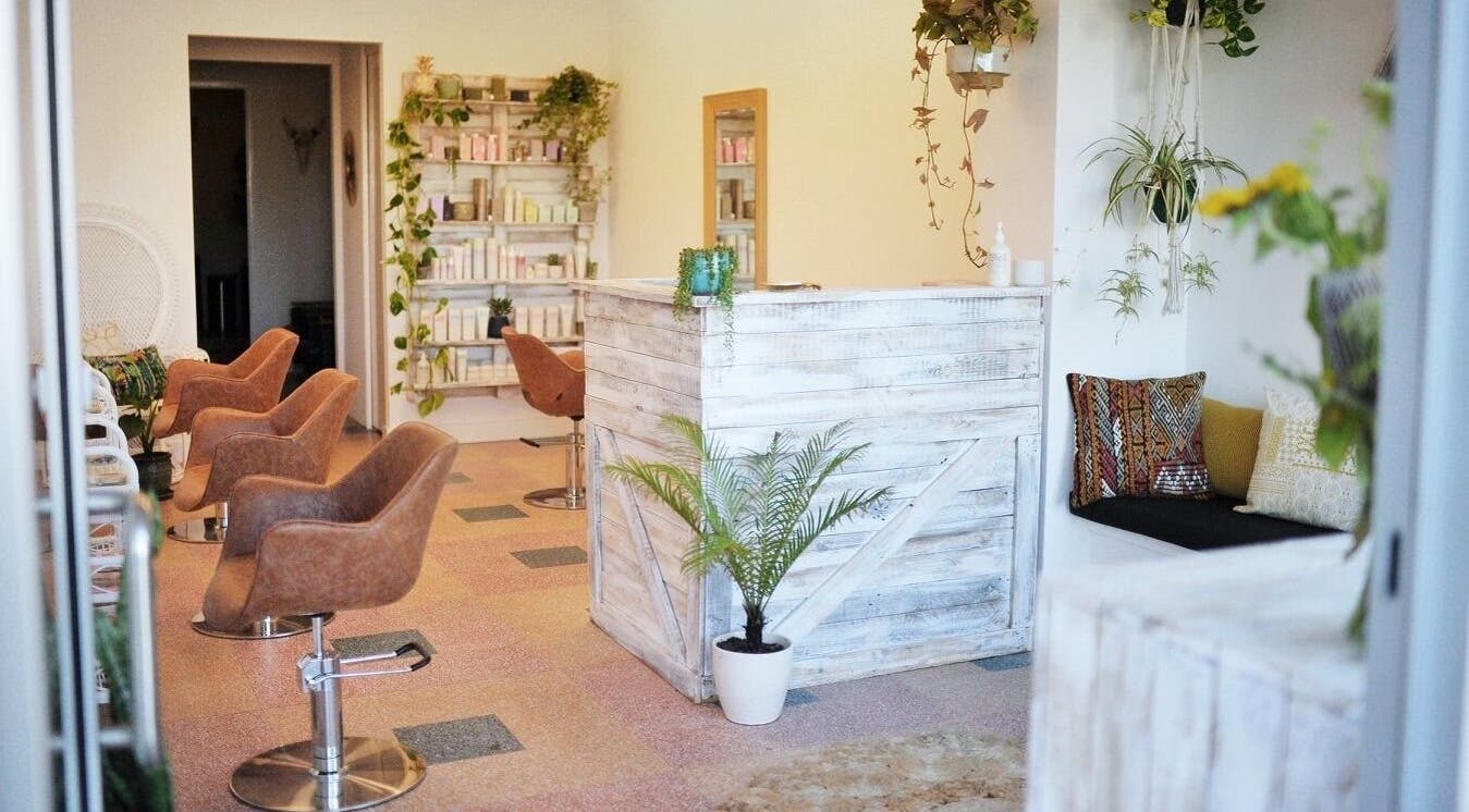 Boho Bombshell salon in White Gum Valley features rustic decor with chic styling chairs and lush greenery.