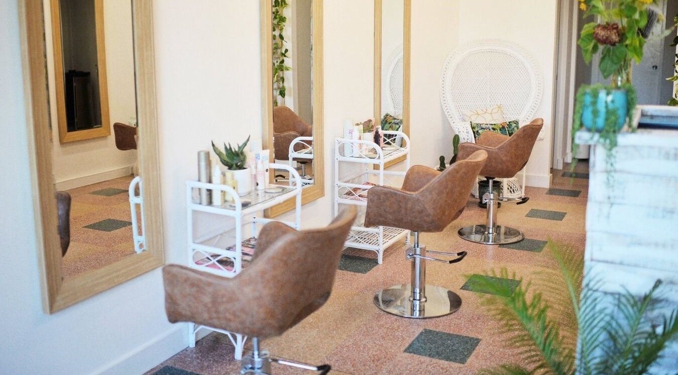 Elegant salon interior at Boho Bombshell, White Gum Valley, Western Australia, AU with stylish mirrors and chairs.
