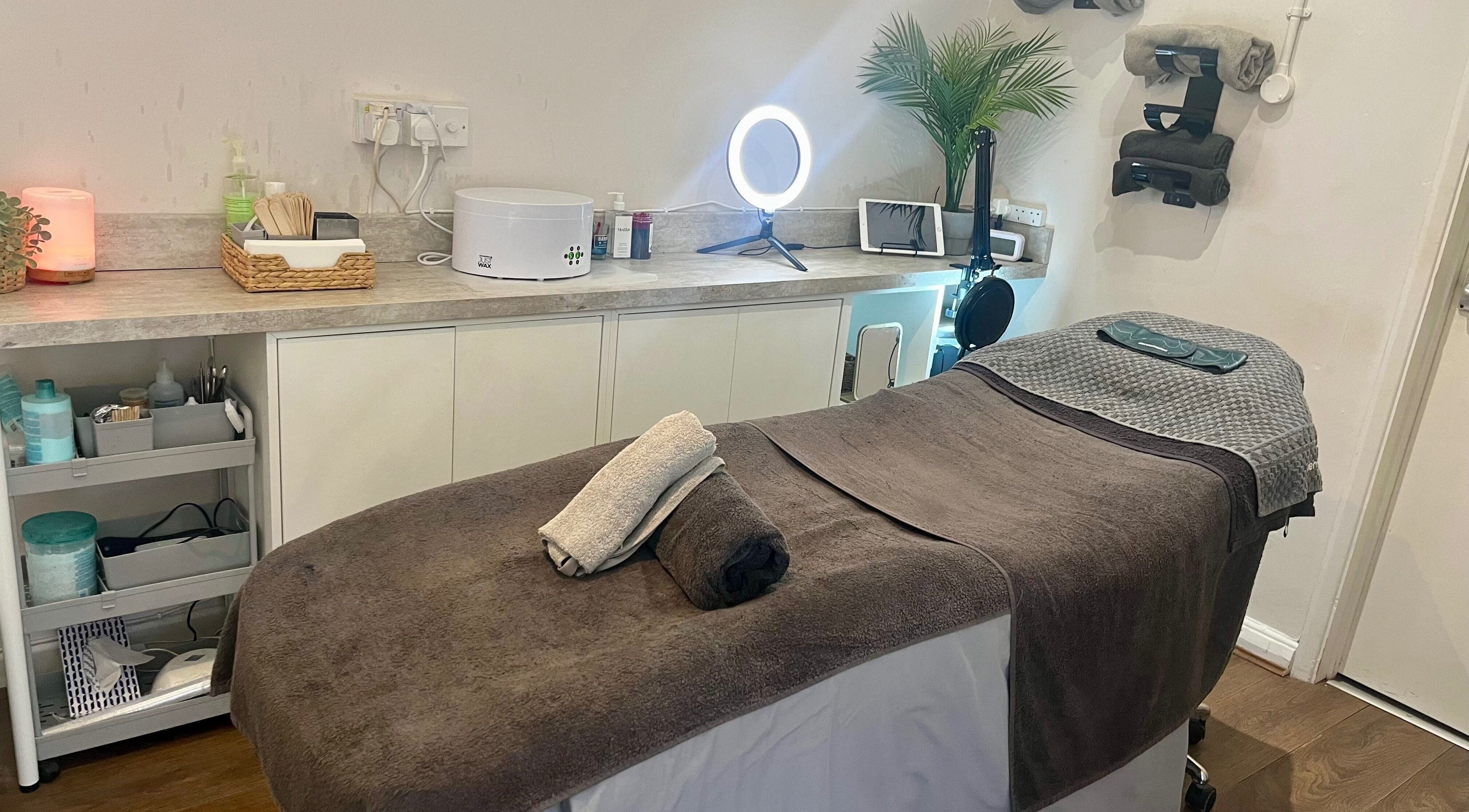 Cozy treatment room at Revive The Beauty Salon, Letchworth Garden City, England, GB with warm lighting and tidy setup.