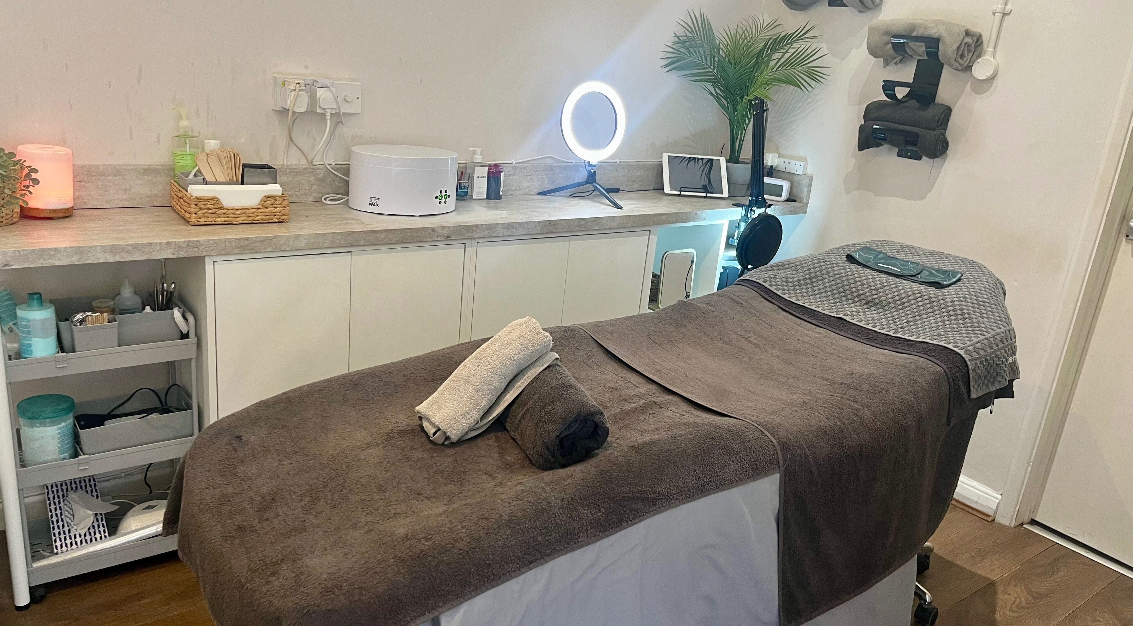 Cozy treatment room at Revive The Beauty Salon, Letchworth Garden City, England, GB with warm lighting and tidy setup.