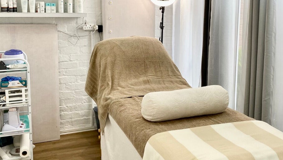 Relaxing massage room at MK Beauty Tokai, Cape Town, Western Cape, ZA with bed and products.